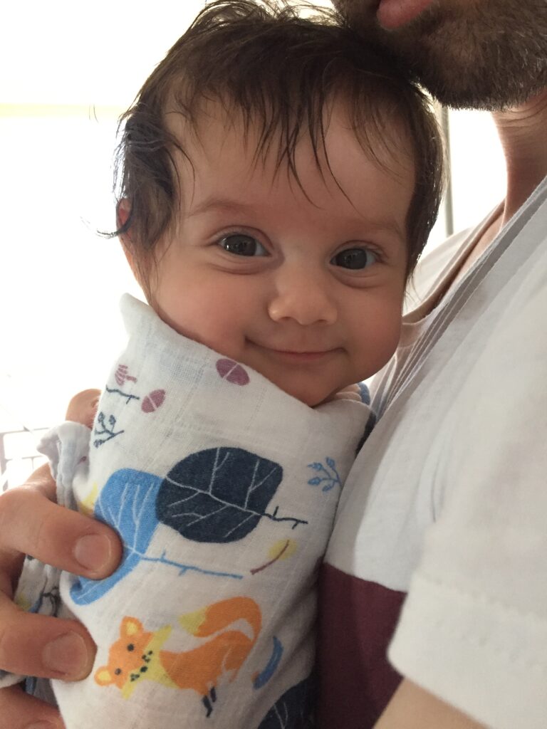 baby smiling being close to her dad
